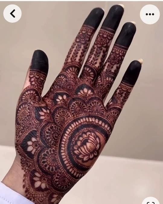 a person's hand with henna tattoos on it