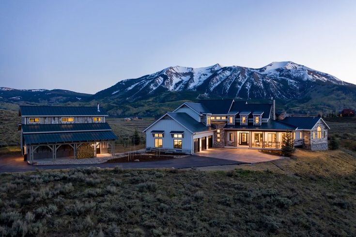 a large house with mountains in the background