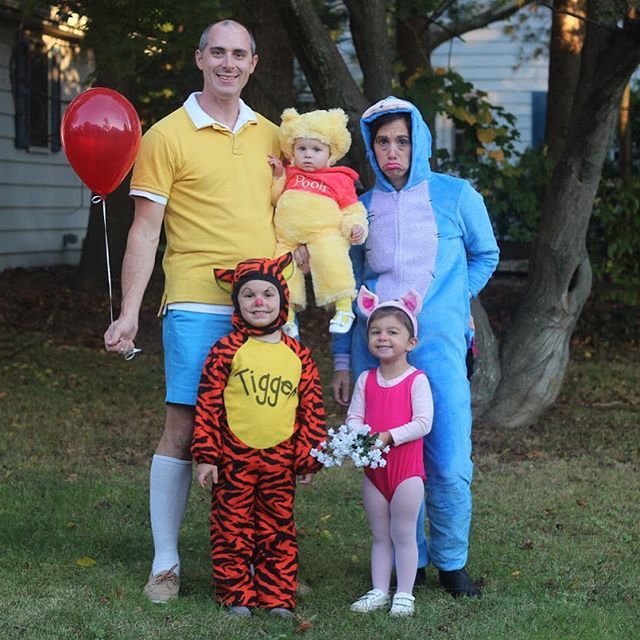 a family dressed up as winnie the pooh and tigger