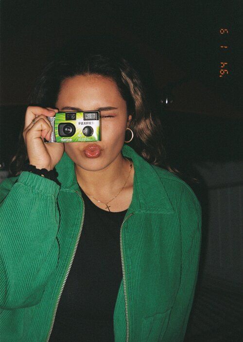 a woman holding a camera up to her face