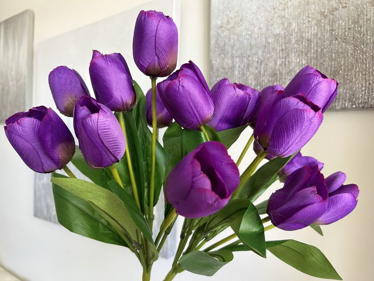 purple tulips in a vase on a table