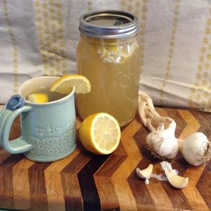 a jar of lemonade and garlic on a cutting board