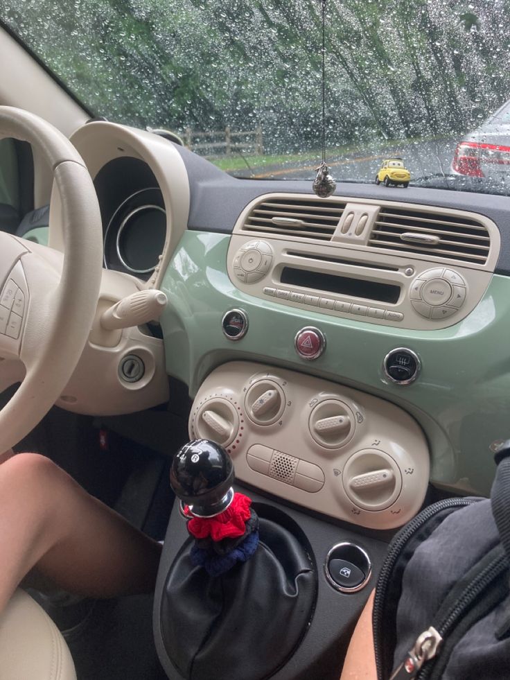 the interior of a car with dashboard controls and steering wheel knobs in front of it