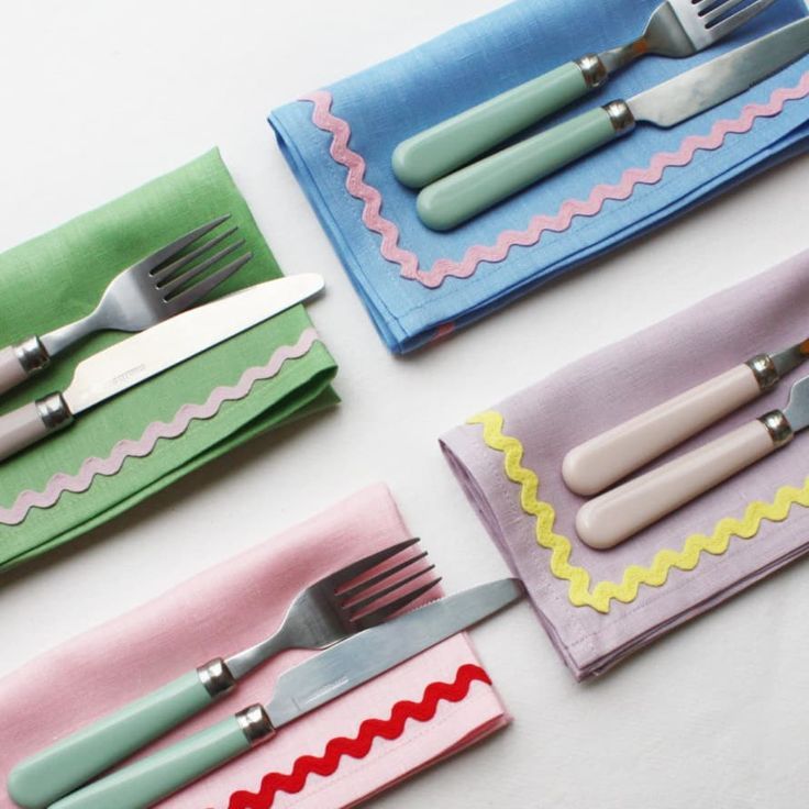 four napkins with forks and knives on them