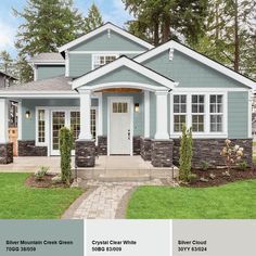 a house with white trim and gray sidings is featured in this brochure