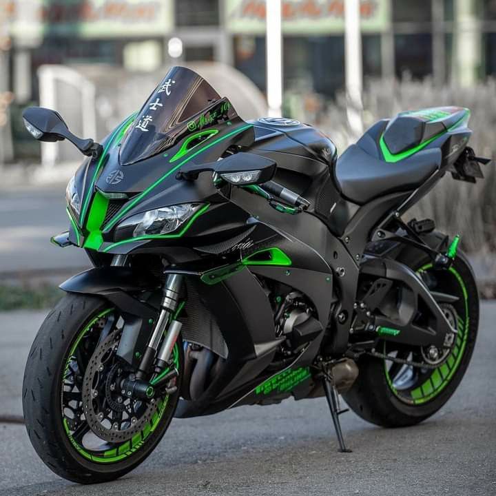 a green and black motorcycle parked on the street