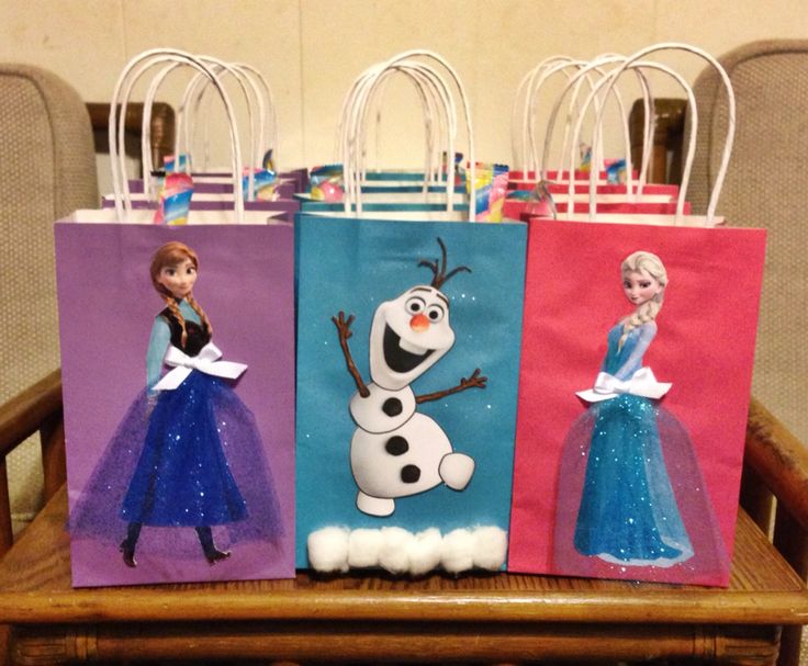 three bags with frozen princesses on them are sitting on a wooden chair in front of some chairs