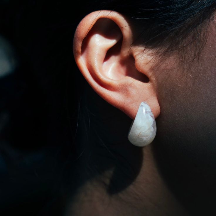 "Introducing our \"Fulfilling Love\" 925 Silver and White Resin Earrings, a stunning blend of timeless sophistication and modern aesthetics. These earrings are meticulously crafted to showcase the lustrous beauty of 925 silver complemented by the pristine charm of white resin. Material: 925 silver, resin Color: white" Luxury White Earrings For Everyday, Timeless White Pierced Earrings, White Sterling Silver Hoop Earrings For Formal Occasions, Formal White Sterling Silver Hoop Earrings, Timeless Teardrop Sterling Silver Pearl Earrings, White Sterling Silver Pearl Earrings, Timeless White Pearl Earrings In Sterling Silver, Touch Love, Blue Tigers Eye