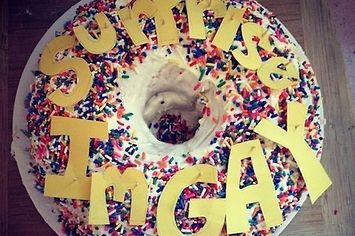 a birthday cake with sprinkles and letters on it