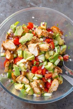 a glass bowl filled with chopped vegetables and meat