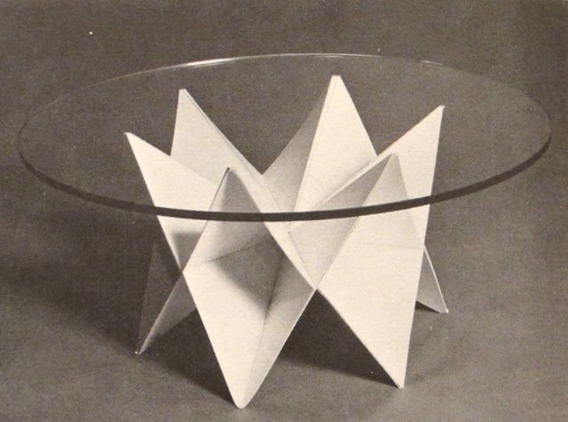 a glass table with an origami design on the top and bottom, in black and white