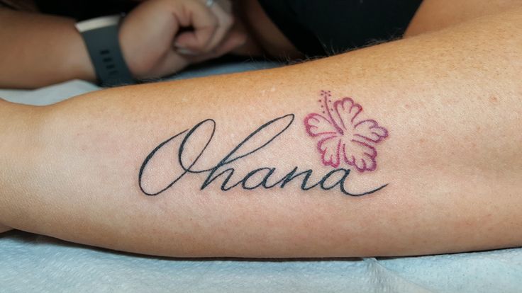 a woman with a tattoo on her arm that says shana and has a butterfly