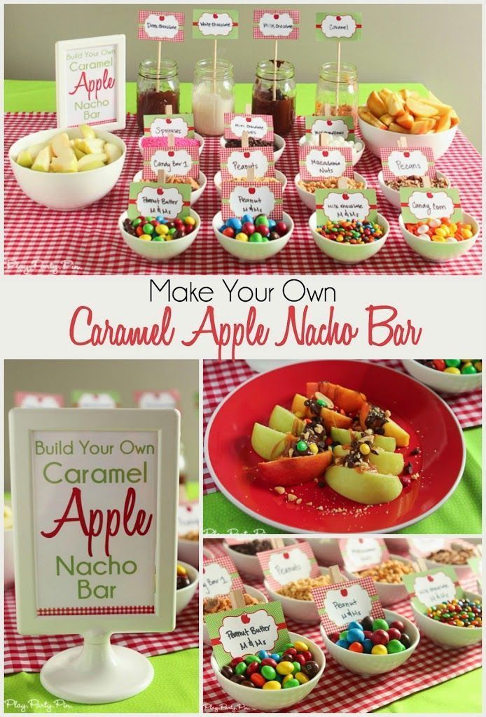 a table topped with lots of food and desserts next to a sign that says make your own caramel apple nacho bar