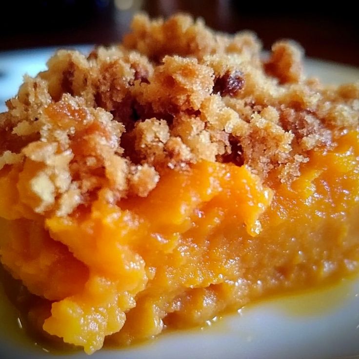 a close up of a plate of food with crumbs on the top and bottom