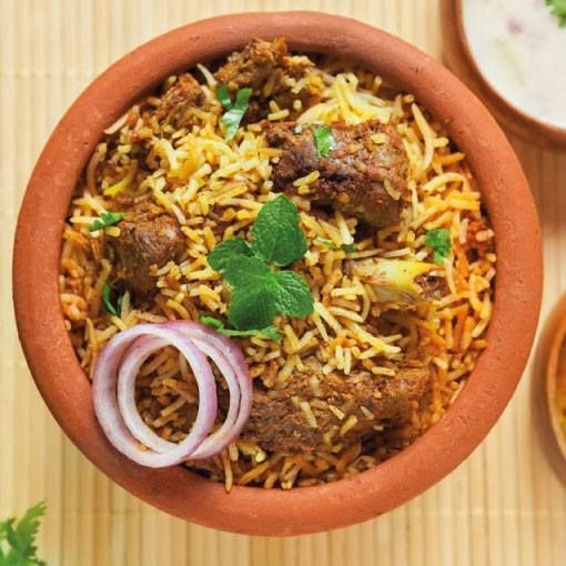 a brown bowl filled with rice and meat