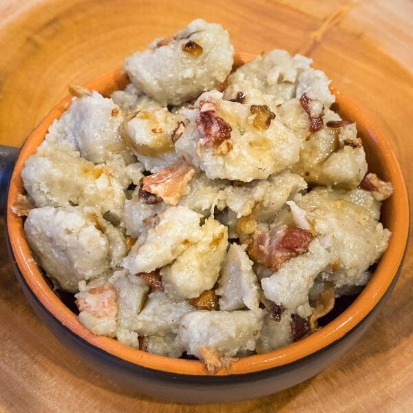 a bowl filled with food sitting on top of a wooden table