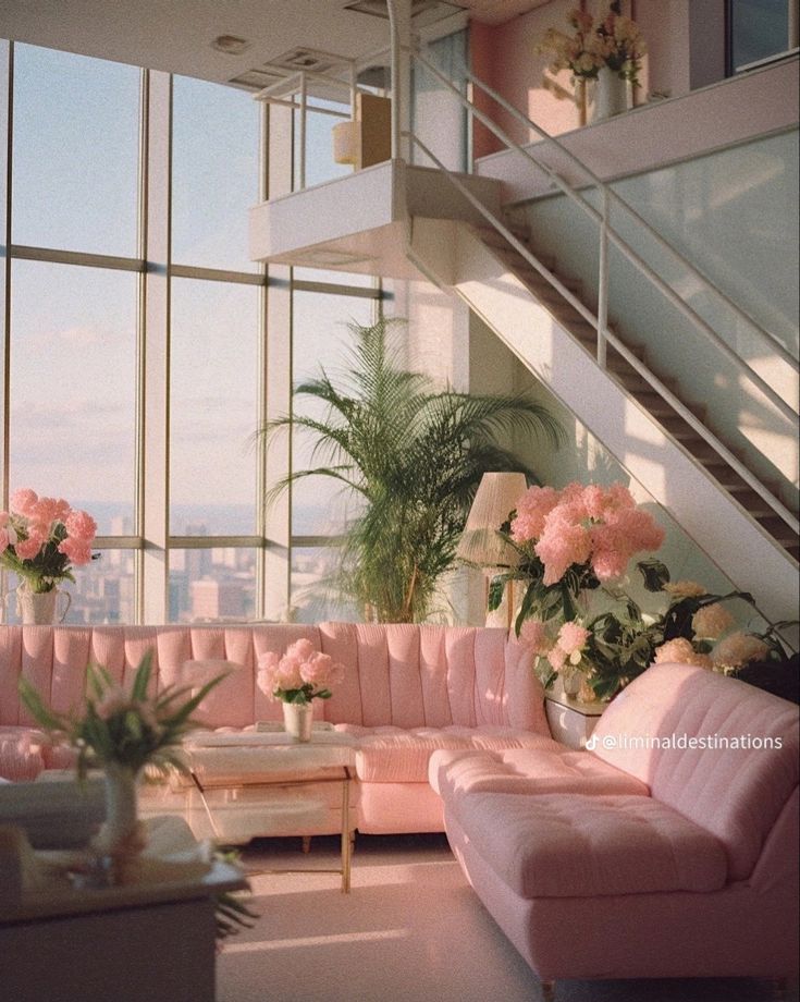 a living room filled with pink couches and lots of flowers on top of them