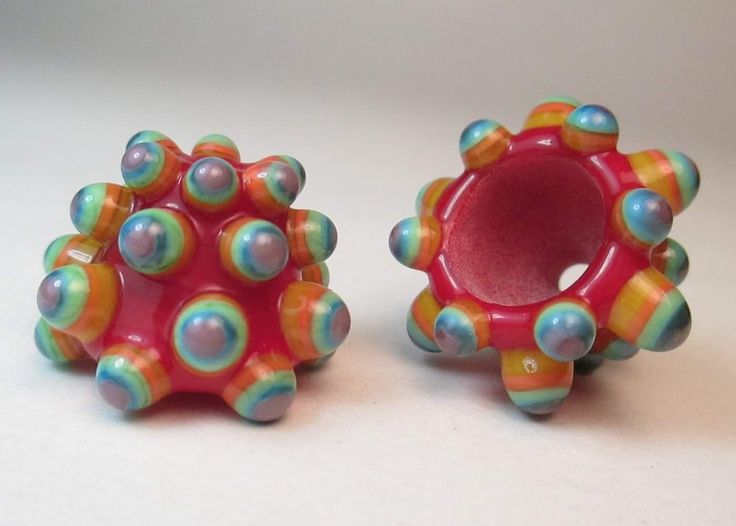 two colorful beads are sitting next to each other