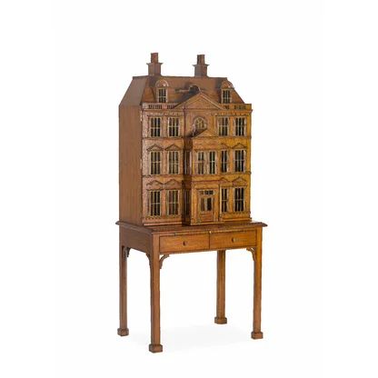 a doll house sitting on top of a wooden table