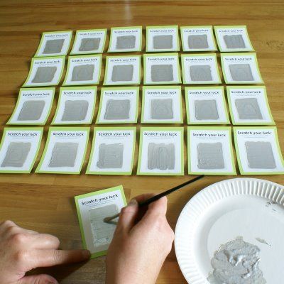 a person is cutting out some cards with scissors