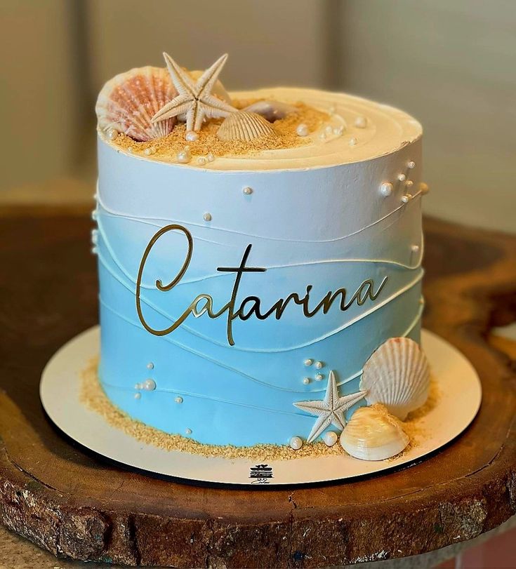 there is a blue cake with shells and starfish on the top that says catalina