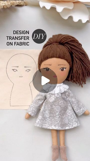 an image of a doll made out of paper with the words design transferer on fabric