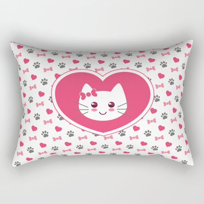 a pink heart shaped pillow with a cat on it