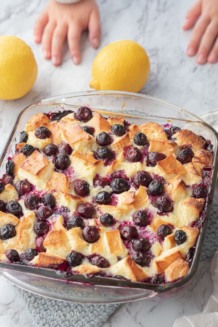 a blueberry cobbler with two lemons on the side