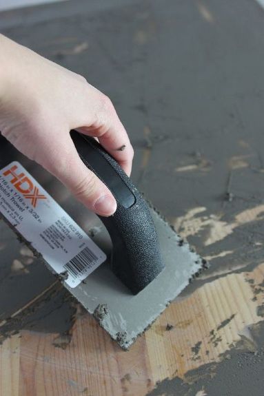 a person is using a sanding tool on a piece of wood