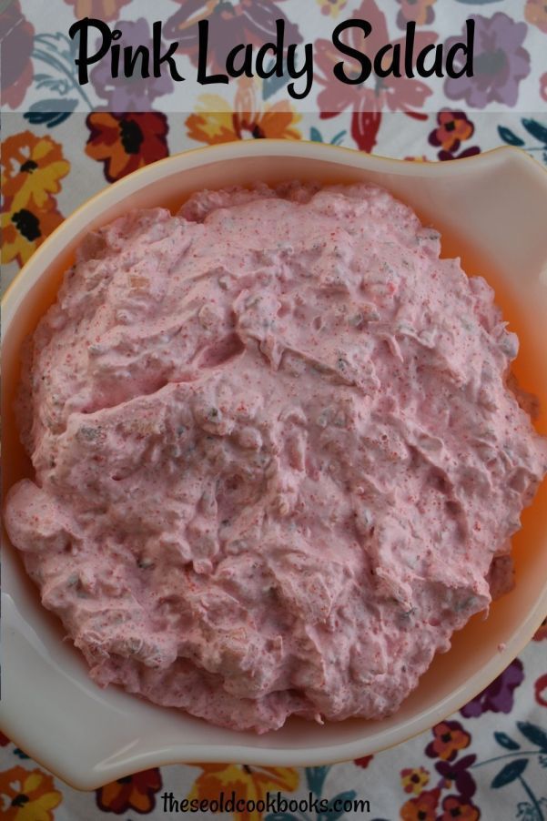 a bowl filled with pink lady salad on top of a table