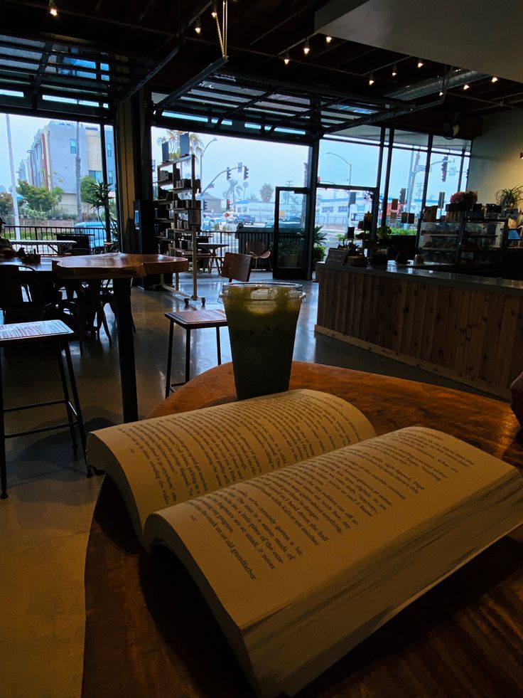 an open book sitting on top of a wooden table