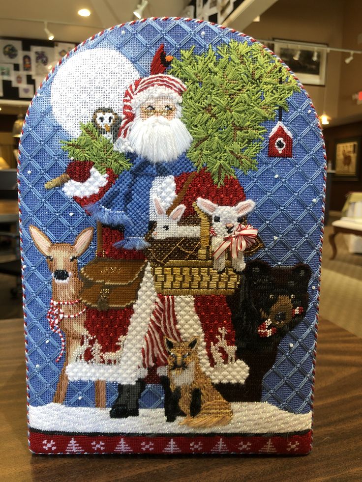 a christmas card holder with santa and his animals