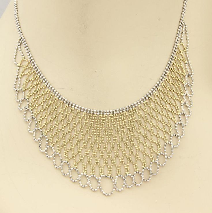 "A unique and beauiful vintage beaded drape necklace. It is well crafted from solid 14k yellow and white gold with a fine polished finish. The chain is a white gold double beaded strand with a a lobster clasp, the wide centerpiece is outlined with white gold, the end in a fancy woven design, set between the white gold is a woven design of beaded yellow gold set in a lovely liquid bib style. This amazing necklace look and feel fabulous around the neck. Will compliment a formal attire. Material: 1 Gold Beaded Chain Jewelry For Evening, Gold Jewelry With Beaded Chain For Evening, Elegant Bib Necklace With Beaded Chain, Elegant White Jewelry With Ball Chain, Elegant White Ball Chain Necklace, Formal Silver Jewelry With Gold Beads, Elegant Gold Necklace With Silver Beads, Formal Silver Necklace With Gold Beads, Elegant Silver Bib Necklace With Beaded Chain