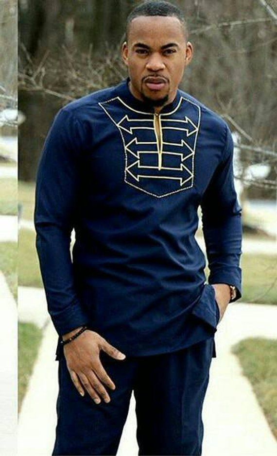 Gold embroidered Africanshirt for men. Long sleeves, made in navy blue polished cotton fabric. The set includes a shirt and pant. Other colors are available. Custom order available, wholesale available( comes with discount). All our outfits are made with great fabrics and we use great African Style Clothing, Ghana Dresses, Ghana Clothes, Modern African Clothing, African Suit, Nigerian Men Fashion, African Tops, African Dashiki, Fashion Stand