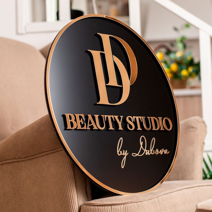 the beauty studio sign is on top of a chair