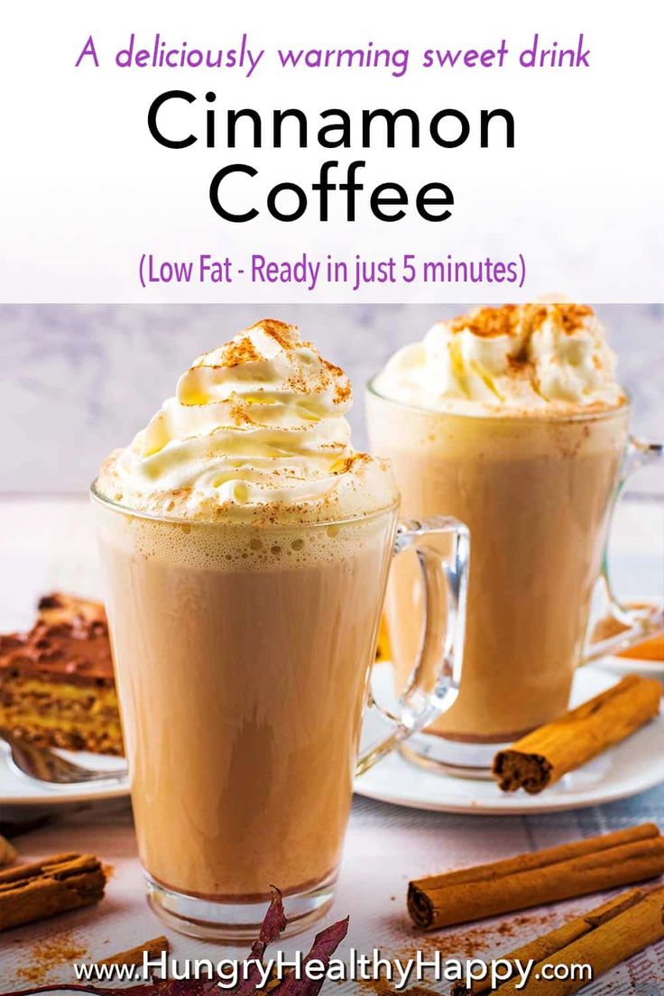 two mugs filled with cinnamon coffee sitting on top of a white table next to cinnamon sticks