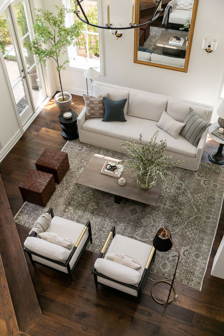 an aerial view of a living room with couches, chairs and a coffee table