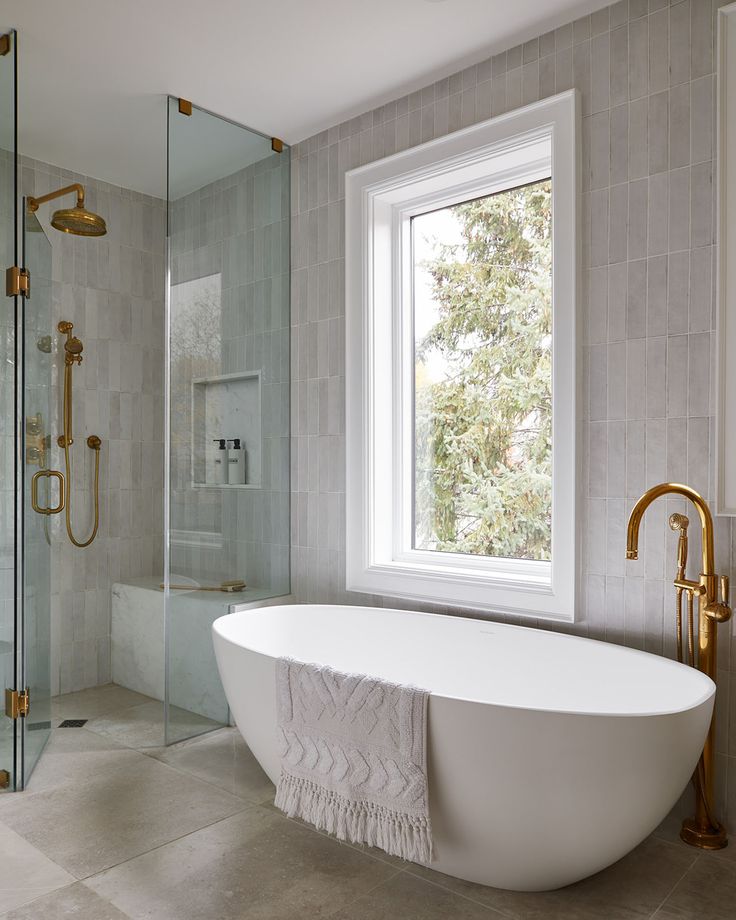 a white bath tub sitting next to a window