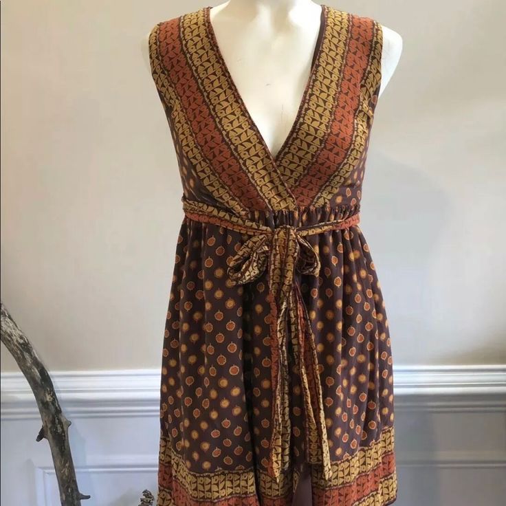 Brand New With Tags! Never Been Worn! Brown And Mustard Anna Sui For Target Wrap Mini Dress With Sleeveless, Surplice Neckline, Sash Tie At Waist, And Snap Closure At Front Waist. Fabric: Shell - 100% Silk, Lining - 100% Polyester Measurements: Waist 24”, Pit To Pit 15”, Length 33” Bohemian Mini Dress With Tie Waist, Yellow Bohemian Knee-length Midi Dress, Fitted Knee-length Bohemian Sundress, Fitted Bohemian Knee-length Sundress, Mustard Knee-length Mini Dress For Summer, Brown Flowy Sleeveless Midi Dress, Bohemian Yellow Sleeveless Mini Dress, Fitted Bohemian Sleeveless Mini Dress, Fitted Yellow Bohemian Midi Dress