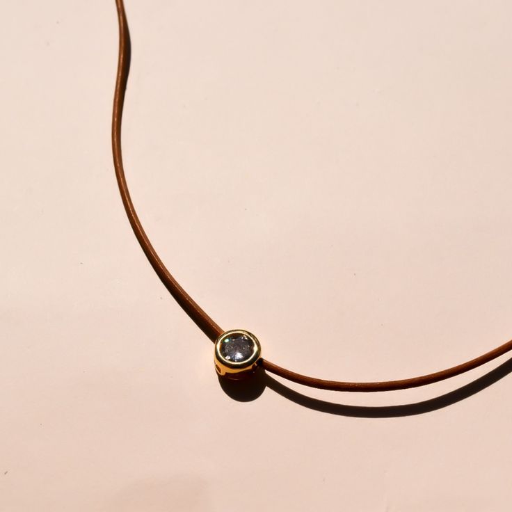 Brown leather strap with diamond charm 15-17 inches in length Chic Gold Jewelry With Leather Strap, Chic Silver Leather Jewelry, Minimalist Leather Jewelry With Adjustable Cord, Elegant Leather Necklace With Adjustable Cord, Everyday Silver Leather Necklace, Minimalist Adjustable Leather Necklace, Adjustable Minimalist Leather Necklace, Elegant Adjustable Leather Necklaces, Modern Leather Choker Jewelry