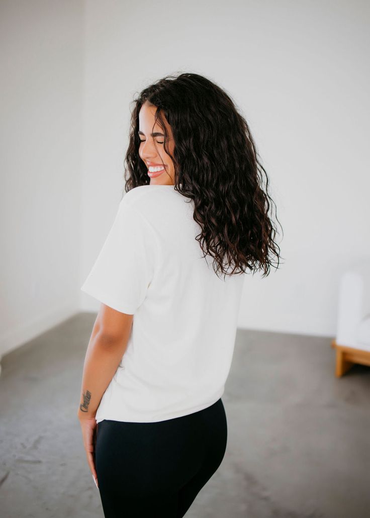 Short Sleeve crew neck graphic tee, loose in all the right places. Featuring an open neckline with slightly dropped sleeves. Made in our soft 100% cotton fabrication. Serenity is wearing a size small. Measurements: Body Length: 30" | Sleeve Length: 9" Small: Bust: 38" Arm: 16" Medium: Bust: 39" Arm: 17" Large: Bust: 43" Arm: 17.5" XL: Bust: 48" Arm: 18" 100% Cotton Effortless Short Sleeve T-shirt For Loungewear, White Relaxed Short Sleeve T-shirt, Trendy White Organic Cotton Tops, Effortless Relaxed Fit T-shirt For Loungewear, Relaxed Graphic Print Tops For Everyday, Relaxed White Tops With Graphic Print, White Relaxed Tops With Graphic Print, Relaxed Crew Neck Short Sleeve Top For Everyday, Relaxed White Top With Graphic Print