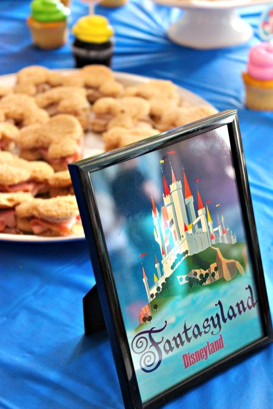 there are many desserts and pastries on the table at this disneyland birthday party