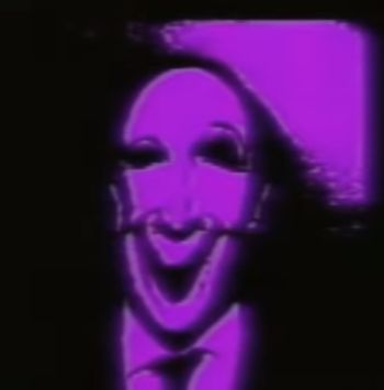 a man wearing a mask and tie in front of a purple screen with the image of a person's face