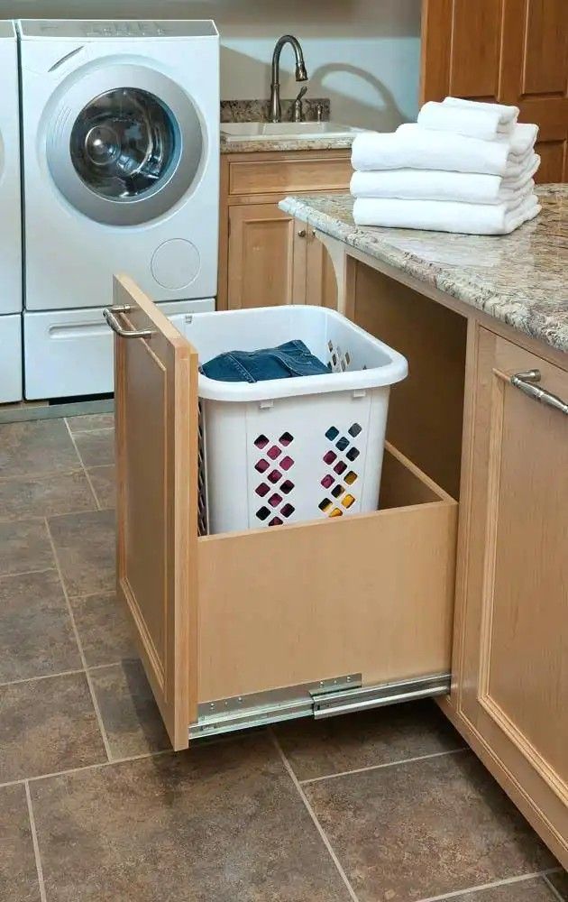 a kitchen with a washer and dryer in the middle of it's cabinets