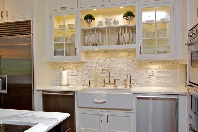 a kitchen with white cabinets and stainless steel dishwasher in the center, next to an oven