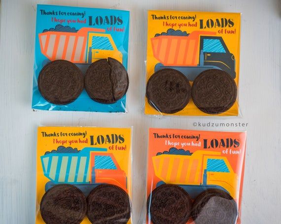 four oreo cookies with chocolate frosting on them are in the package, and one is