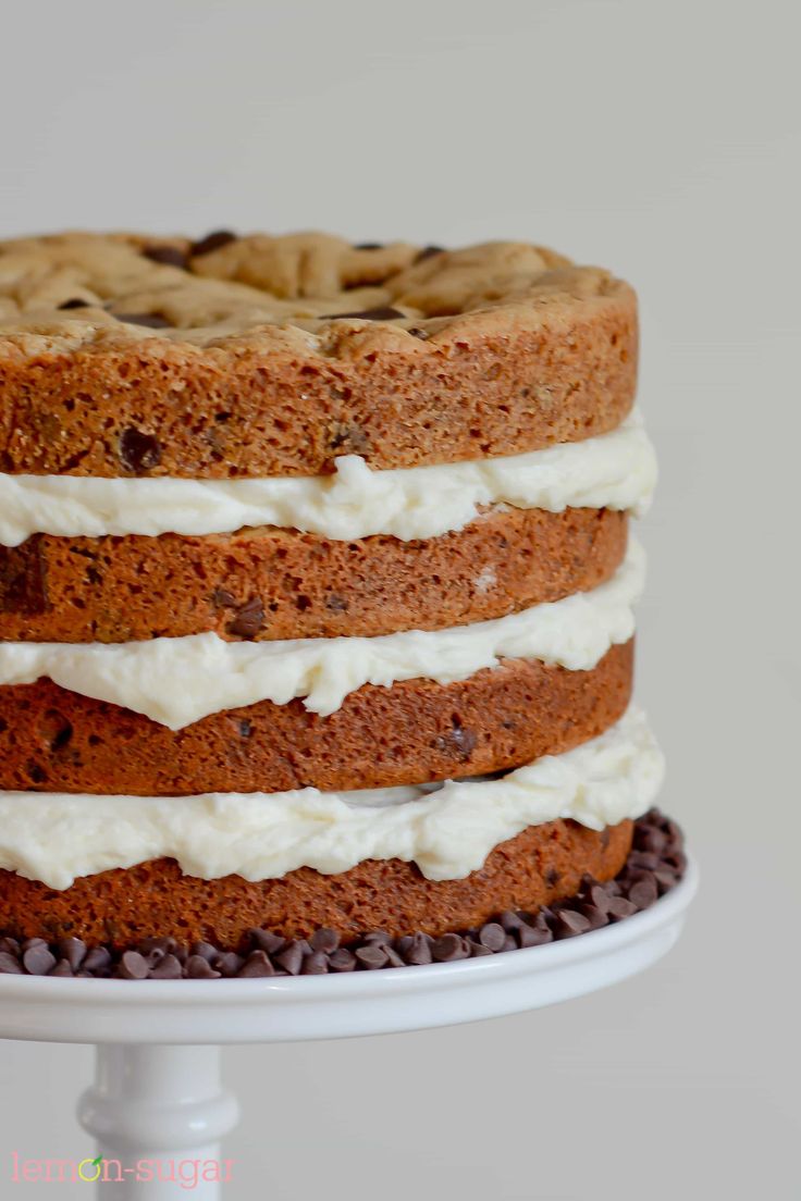 a cake with white frosting and chocolate chips on top