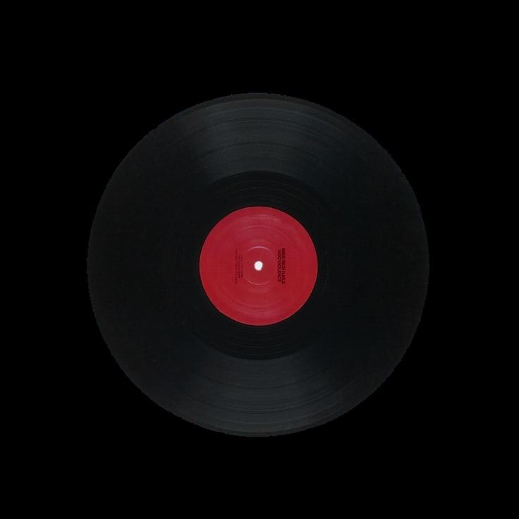 an old black record with red disk in the middle on a black background, taken from above