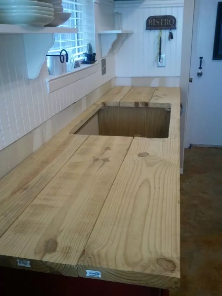 a wooden counter top sitting inside of a kitchen