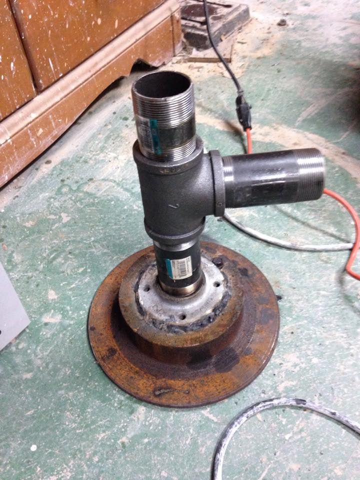 an old metal object sitting on top of a floor